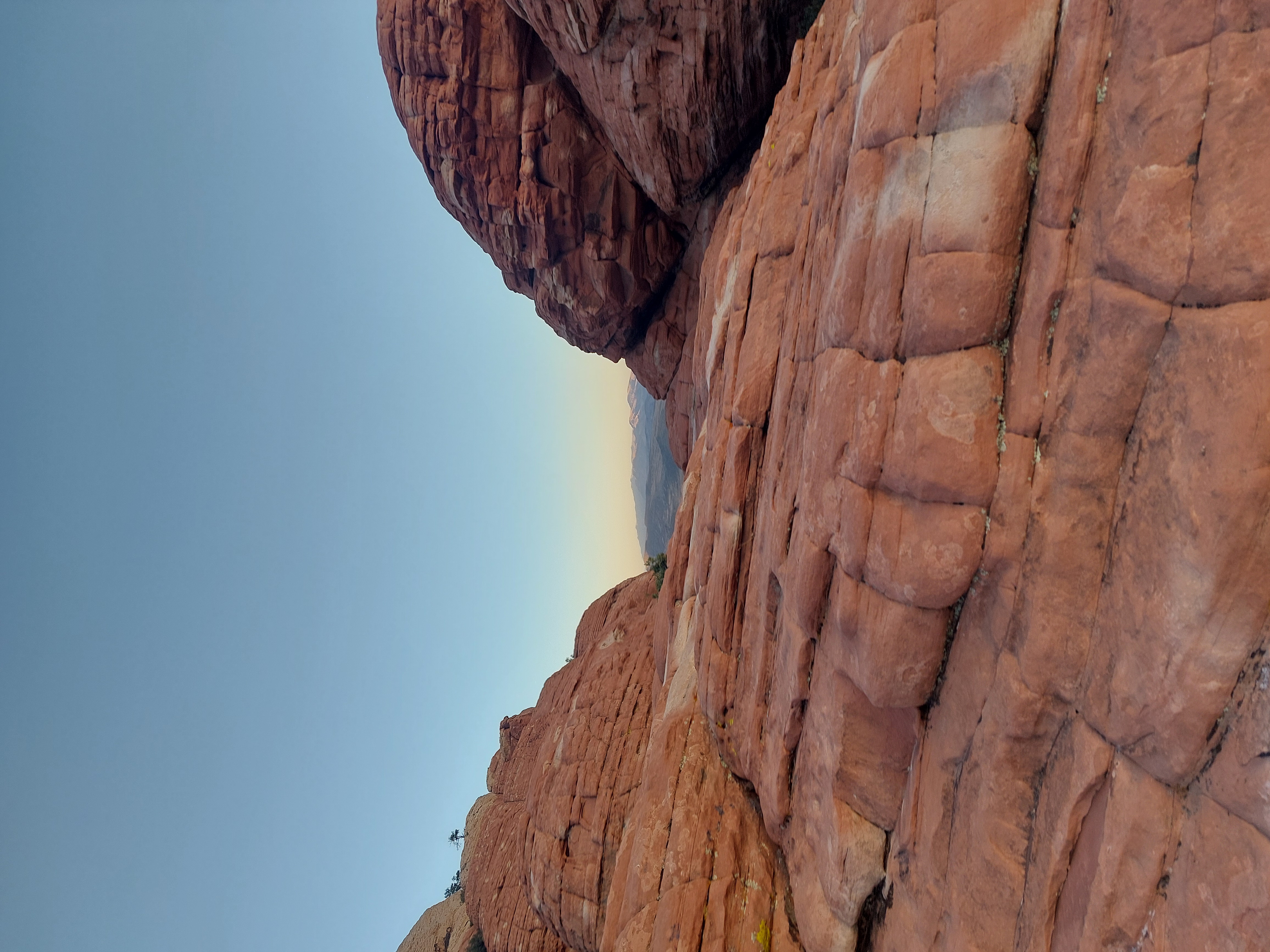 Red sandstone formations framing distant mountains under a blue sky.